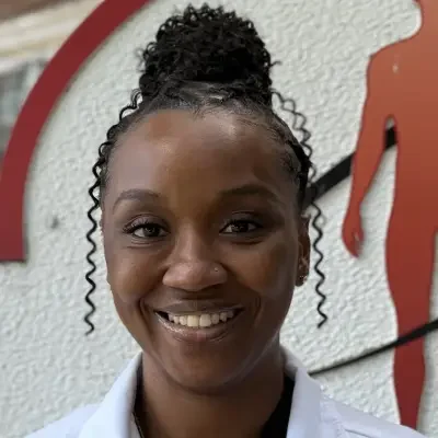 Staff member in white shirt and smiling